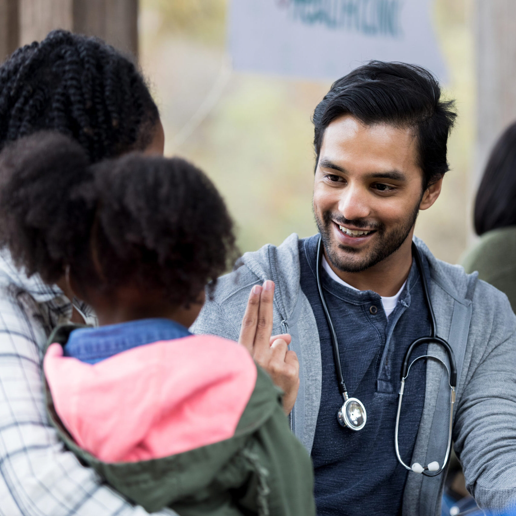 Doctor checks patient's vision at outdoor free clinic